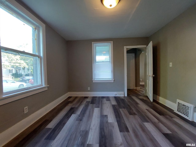 unfurnished bedroom featuring dark hardwood / wood-style floors