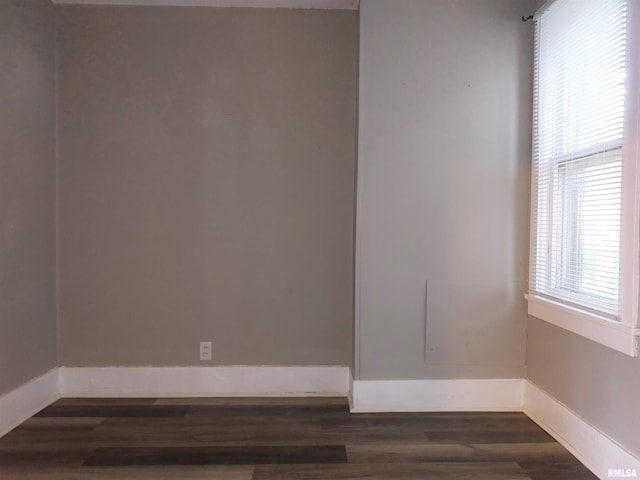 empty room with dark hardwood / wood-style floors