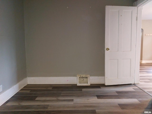 spare room featuring dark hardwood / wood-style flooring