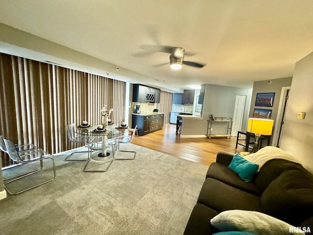 living room featuring ceiling fan and light hardwood / wood-style flooring