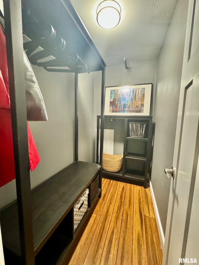 mudroom with a textured ceiling and hardwood / wood-style flooring