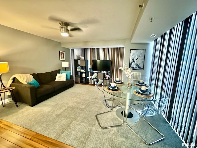 living room with ceiling fan and carpet flooring