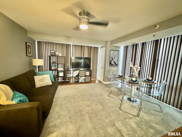 carpeted living room featuring ceiling fan