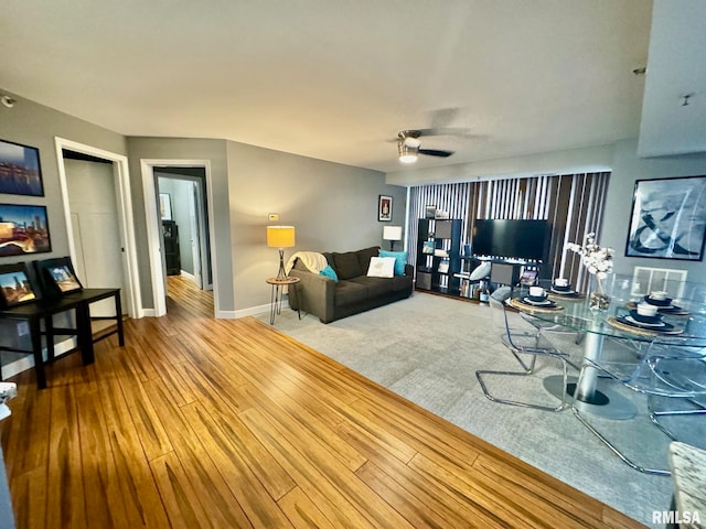 living room featuring ceiling fan and hardwood / wood-style floors