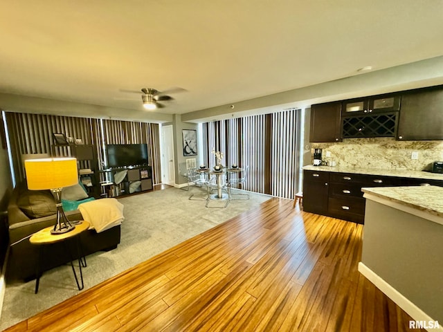 living room with light hardwood / wood-style flooring and ceiling fan