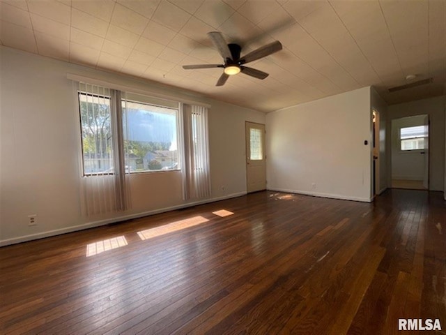 unfurnished room featuring ceiling fan and dark hardwood / wood-style flooring