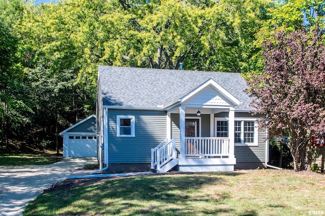 view of front of property featuring an outdoor structure, a front yard, a porch, and a garage