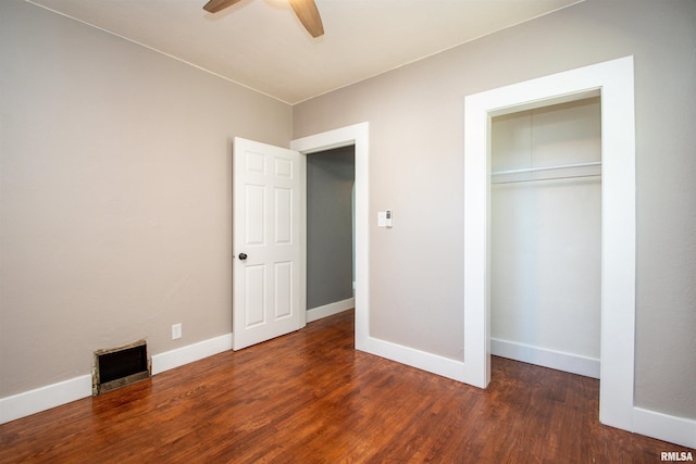 unfurnished bedroom featuring a closet, ceiling fan, and dark hardwood / wood-style flooring