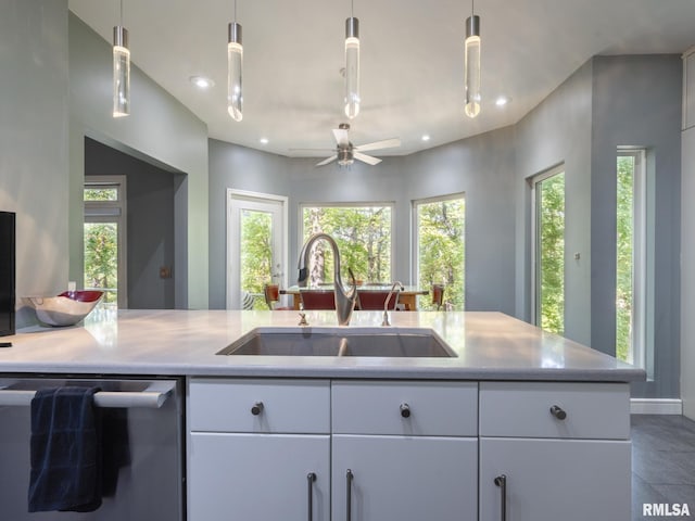 kitchen with sink, hanging light fixtures, dishwasher, and ceiling fan