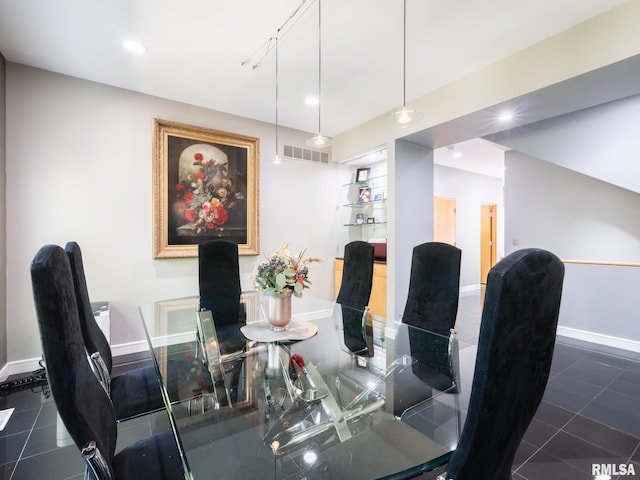 dining area with dark tile patterned flooring