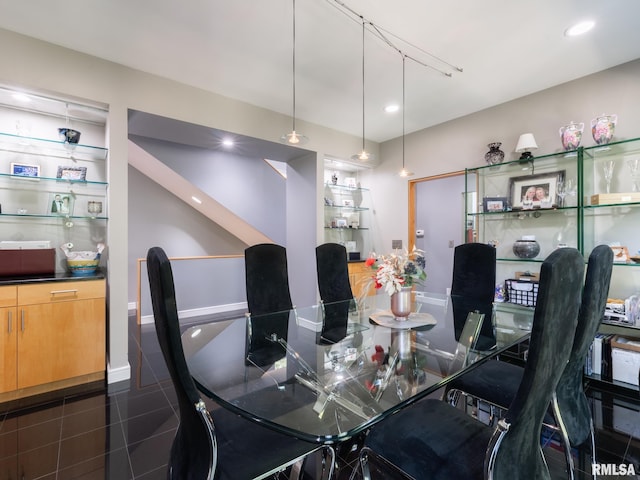 tiled dining space featuring built in features