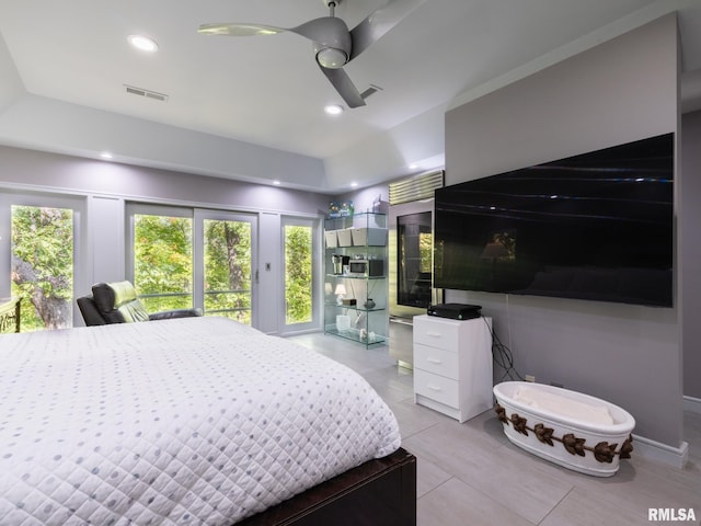 tiled bedroom with multiple windows and ceiling fan