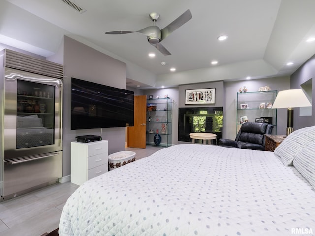 bedroom featuring high end refrigerator and ceiling fan