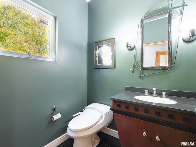 bathroom featuring tile patterned floors, vanity, and toilet