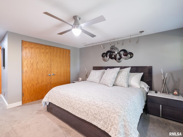 carpeted bedroom featuring a closet and ceiling fan