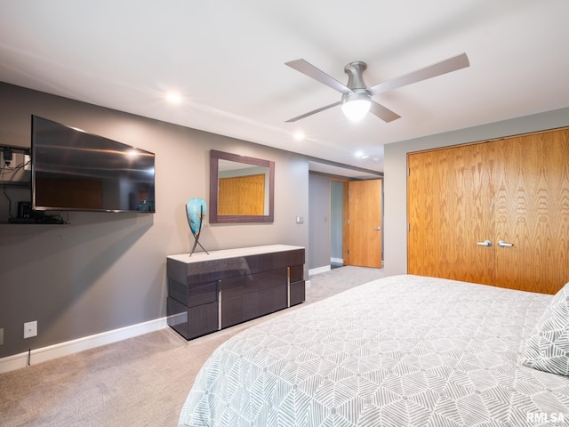 carpeted bedroom featuring a closet and ceiling fan