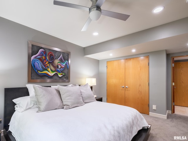 bedroom featuring ceiling fan, a closet, and light carpet