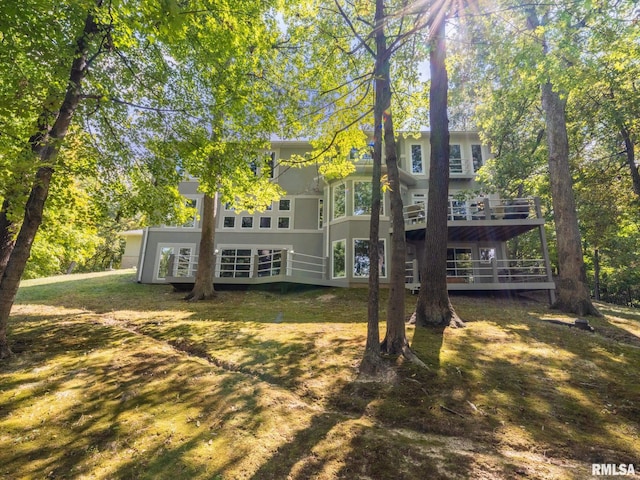 rear view of property with a lawn