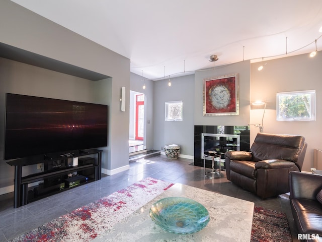 living room featuring a healthy amount of sunlight and dark tile patterned flooring