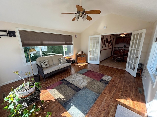 living room with ceiling fan, lofted ceiling, dark hardwood / wood-style floors, and french doors