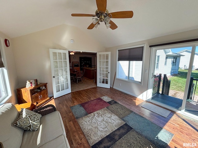 living room featuring lofted ceiling, dark hardwood / wood-style flooring, ceiling fan, and french doors