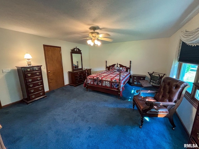 carpeted bedroom with a textured ceiling and ceiling fan