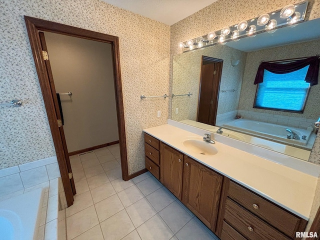 bathroom featuring tile patterned flooring, a tub to relax in, and vanity