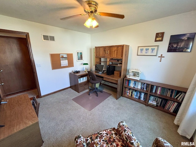 carpeted home office featuring ceiling fan