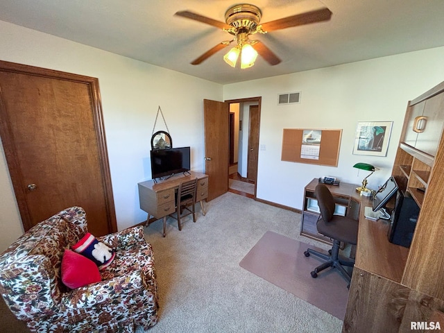 carpeted home office with ceiling fan