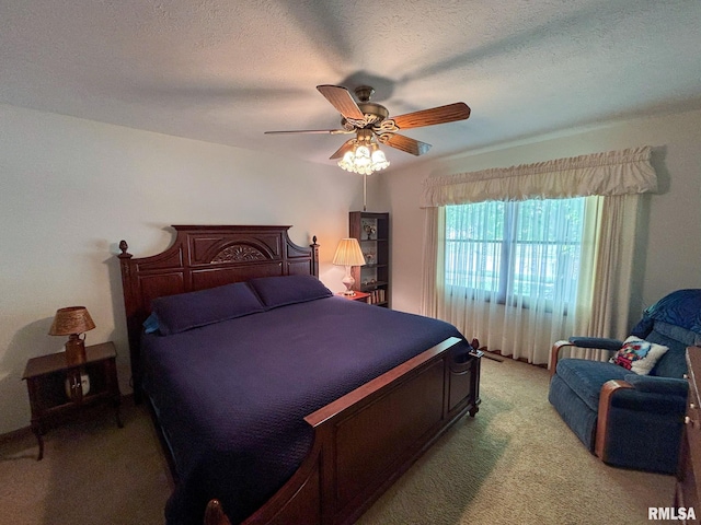 carpeted bedroom with a textured ceiling and ceiling fan