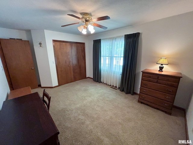 carpeted bedroom featuring a closet and ceiling fan