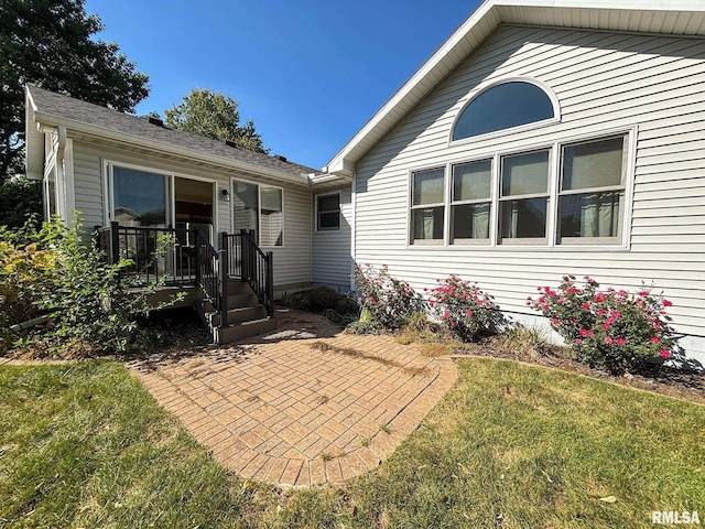 exterior space with a front lawn and a patio area