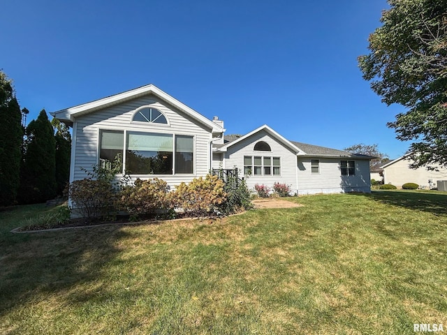 back of house with a lawn