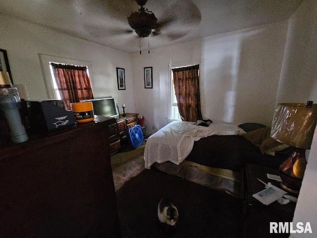 bedroom with ceiling fan, carpet floors, and a textured ceiling