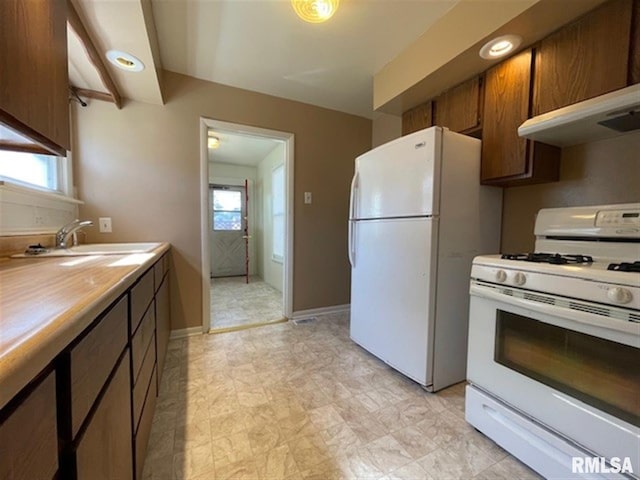 kitchen with white appliances and sink