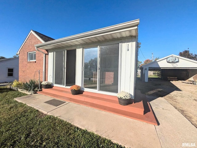 rear view of house with an outbuilding and a garage