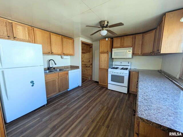 kitchen with white appliances, ceiling fan, dark wood-type flooring, and sink