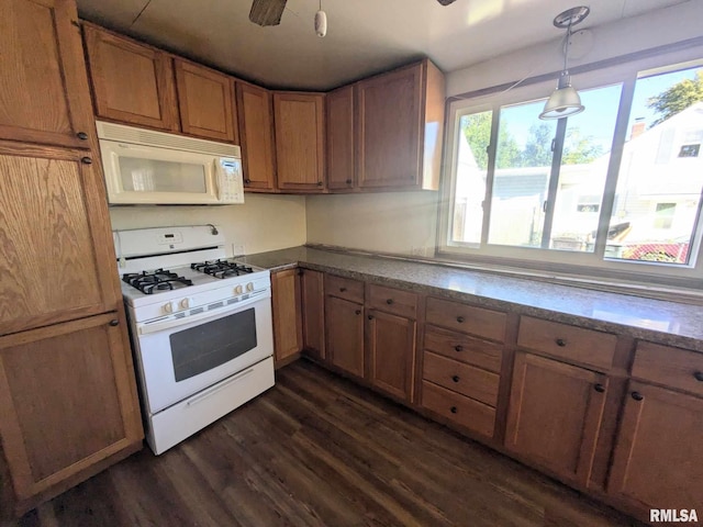 kitchen featuring ceiling fan, pendant lighting, dark hardwood / wood-style floors, and white appliances