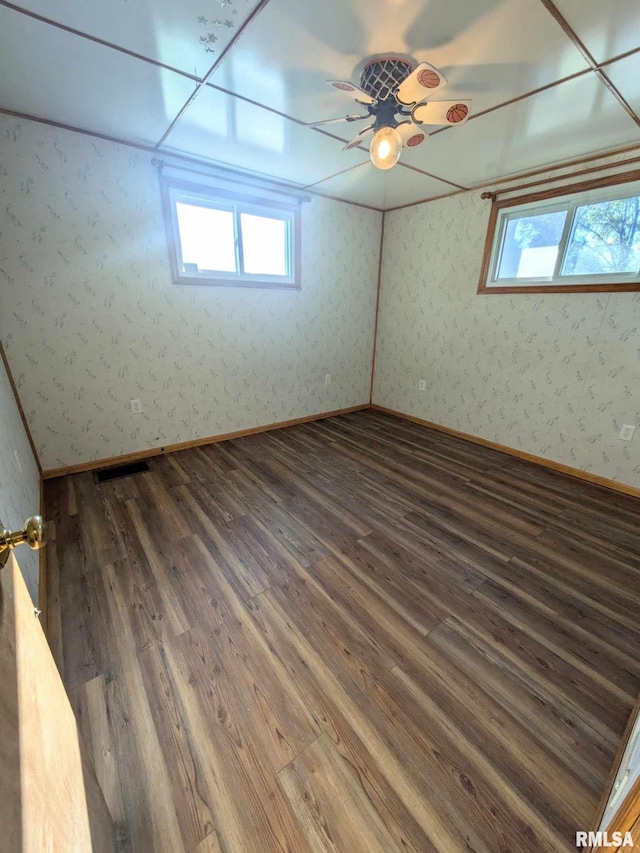 unfurnished room with dark hardwood / wood-style flooring