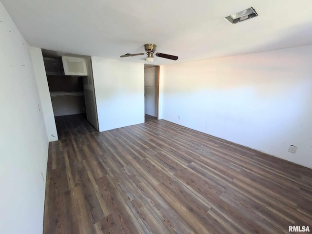 unfurnished bedroom with dark hardwood / wood-style floors, ceiling fan, and a closet