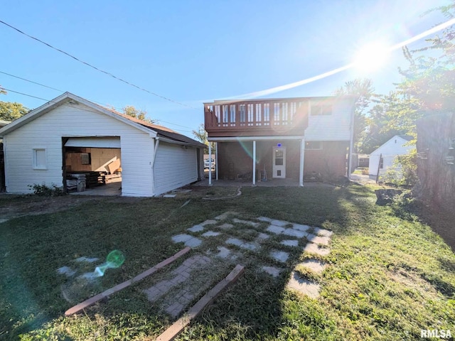 back of property featuring an outbuilding and a yard