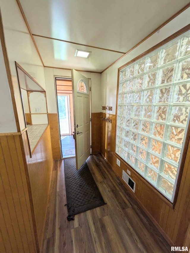 interior space with wooden walls and dark wood-type flooring