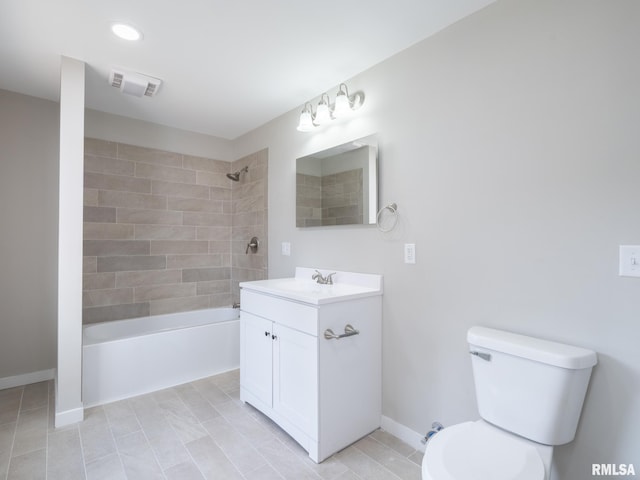 full bathroom with tile patterned floors, tiled shower / bath combo, vanity, and toilet