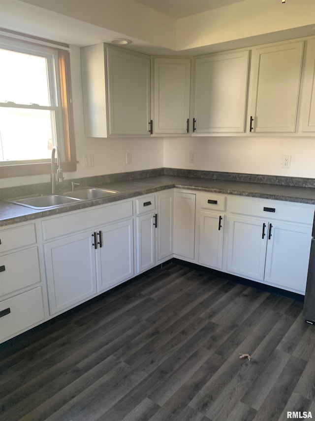 kitchen with white cabinetry, sink, and dark hardwood / wood-style flooring