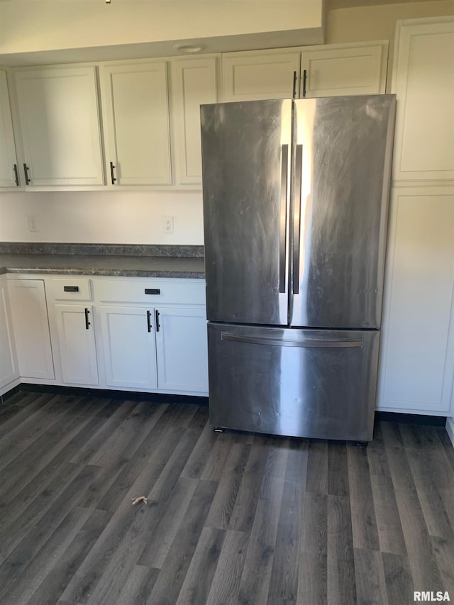 kitchen featuring dark wood-type flooring, white cabinetry, and stainless steel fridge