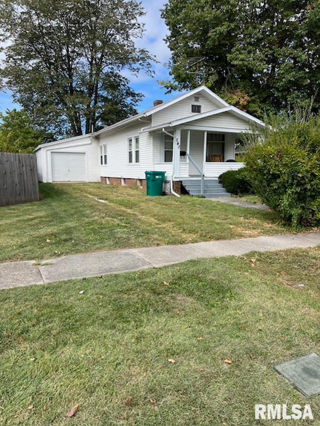 view of front facade featuring a front lawn, covered porch, and a garage