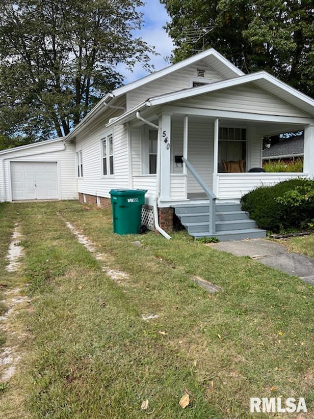 bungalow-style home with a front lawn and covered porch