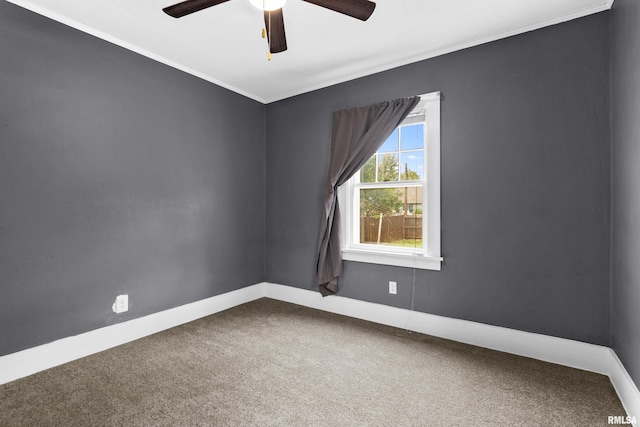 carpeted empty room with ornamental molding and ceiling fan