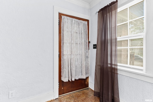 foyer entrance featuring ornamental molding