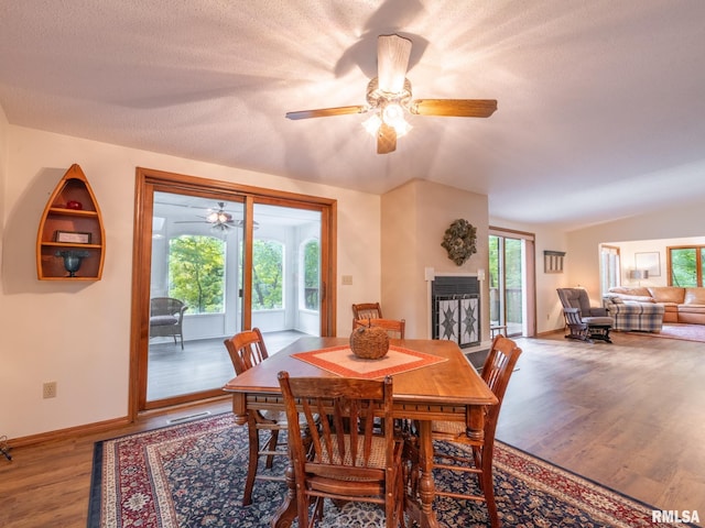 dining room with ceiling fan, lofted ceiling, and wood-type flooring